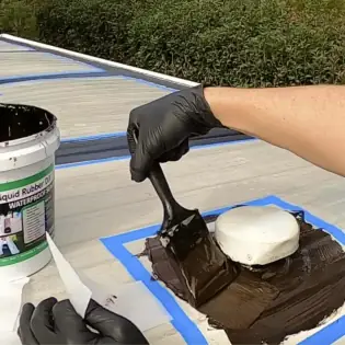 Applying Liquid Rubber sealant to caravan roof seams